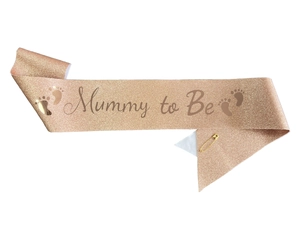 Close-up of rose gold glitter Mummy to Be sash with elegant lettering and baby footprints