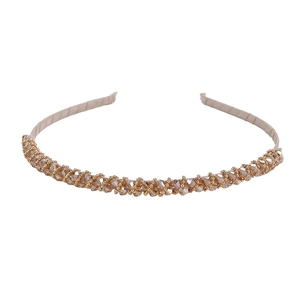 Detail of handmade champagne crystal beads woven on a slim gold metallic headband
