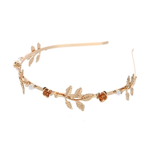 Golden bridal headband with baroque metallic leaves, roses, and white pearls on white background