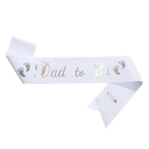 Close-up of Dad to Be sash with laser lettering and baby footprints for baby shower