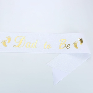 Detail of white Dad to Be sash with gold foil lettering and footprints for baby shower