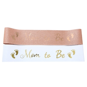 Detail of rose gold glitter and white satin Mom to Be sashes with gold foil lettering