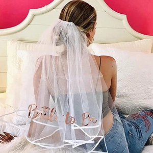 Detail of double-layer white wedding veil featuring rose gold Bride to Be lettering