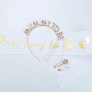 Detail of Mummy to Be party set with rhinestone headband and satin sash with gold lettering