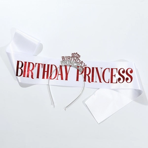 Detail of white Birthday Princess sash and sparkling silver tiara with red rhinestones
