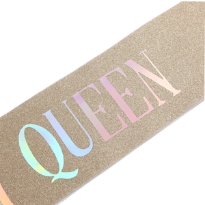 Detail of glitter champagne gold sash with holographic QUEEN text for birthday party