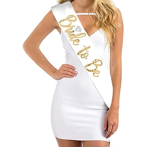 Close-up of white satin Bride to Be sash with elegant gold foil lettering and diamond icon
