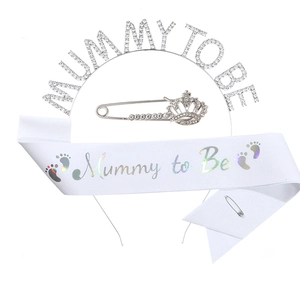 Detail view of Mummy to Be silver rhinestone headband and white satin sash set