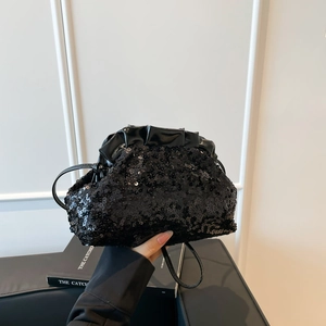 Sparkly black sequin dumpling bag for evening parties with ruffled leather top and strap