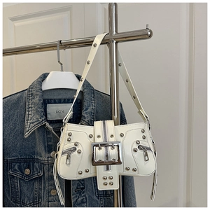Close-up of Y2K punk style white shoulder bag with silver studs and decorative buckles