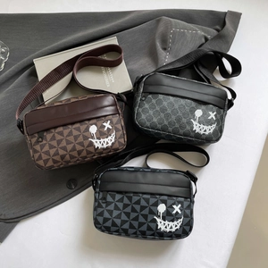 Three trendy crossbody bags with geometric triangle patterns and graffiti smiley faces