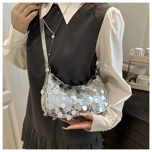 Detailed view of silver sequin crescent shoulder bag with metallic reflective texture