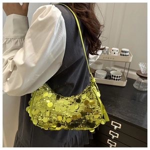 Detail of a crescent shoulder bag with neon yellow sequins and slim strap
