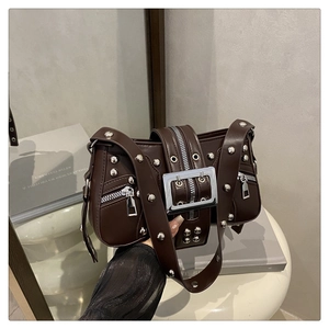 Detail view of dark brown punk shoulder bag with silver studs and large metal buckle