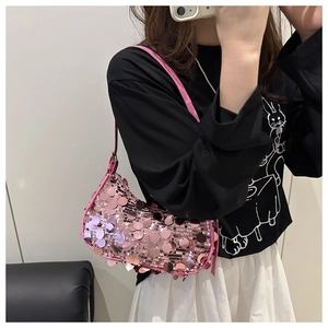 Close-up of pink sequined hobo bag featuring shiny metallic discs and slim leather strap