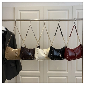 Five assorted colors of vintage half-moon hobo bags with gold rivet studs and chain straps