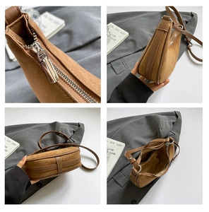 Macro detail of brown suede crescent bag showing silver zipper and internal pocket