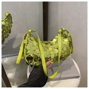 Detailed close-up of bright green sequined crescent bag showing reflective texture