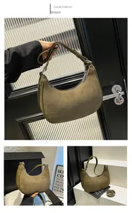 Close-up of olive green faux suede texture and adjustable leather strap on a hobo bag
