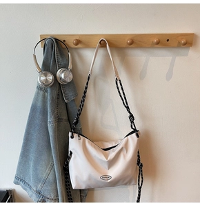 Close-up of a white nylon crossbody bag featuring braided rope straps and GAIFYUN logo