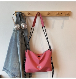 Detail of GAIFYUN nylon messenger bag with pink fabric and spiral rope shoulder strap