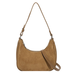 Brown suede crescent underarm bag with smooth leather trim and silver zipper hardware