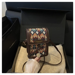 Detail of retro geometric jacquard mini crossbody bag with leather trim in a gift box