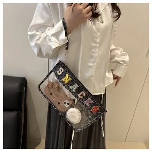 Detailed view of clear PVC bag with leopard trim and SNACKS chenille embroidery