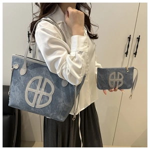 Detailed view of the denim tote bag with letter print and matching small pouch