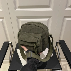 Retro dark green corduroy crossbody bag with woven rope detail and wide shoulder strap
