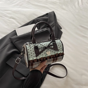 Vintage cylinder shoulder bag with star print, tartan patterns, and lace bow detail