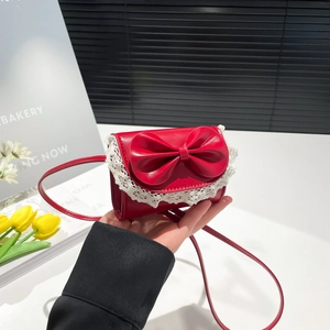 Red small square handbag with a large bow and white lace trim for a sweet retro look