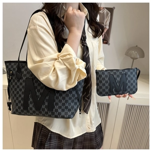 Detail view of large tote and matching clutch set with monogram pattern print