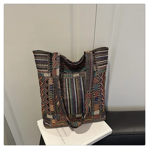 Detailed close-up of retro ethnic woven tote bag with geometric colorful patterns