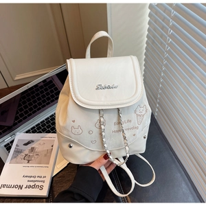 Detail view of mini off-white backpack with cartoon graffiti and chain on books