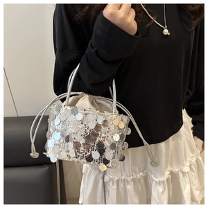 Detailed view of silver sequin bucket bag with drawstring liner and dual handles