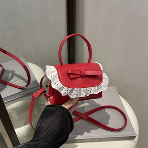 Elegant red mini crossbody bag with delicate white lace trim and chic bow detail