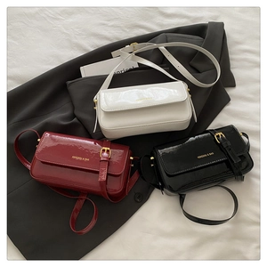 Detailed comparison of glossy patent leather handbags in white, burgundy and black colors