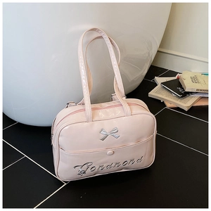Detail of baby pink patent leather tote with silver bow and Gonamond embroidery