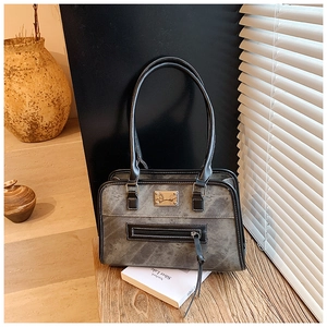 Detail of vintage gray faux leather tote bag with metallic logo and external zipper pocket