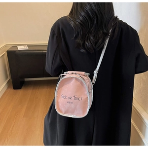Detail view of pink leather backpack featuring a transparent window and artistic lettering