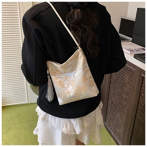 Detailed back view of a vintage landscape brocade crossbody bag with long silk tassels