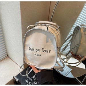 Detailed view of white letter print backpack with silver trim and metallic texture