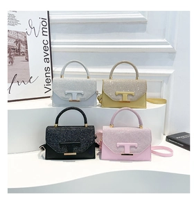 Detail shot of four sequined crossbody bags with T-shaped buckles in a chic display