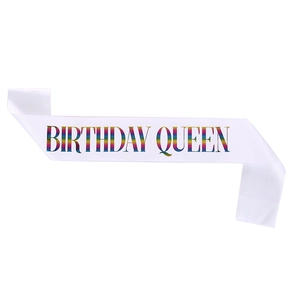 Close-up of white satin sash with rainbow Birthday Queen text for party decor