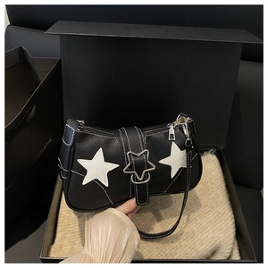 Detail of black pebbled PU leather bag with white star patches and contrast stitching