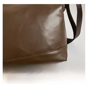Detail showing high-quality stitching and soft PU leather texture of the dark brown tote