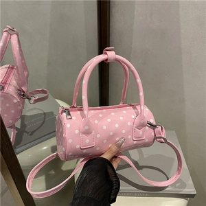Pink polka dot barrel bag with glossy finish and detachable shoulder strap for women