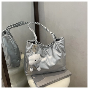 Silver tote bag with woven handle, striped texture, and cute plush cloud charm detail