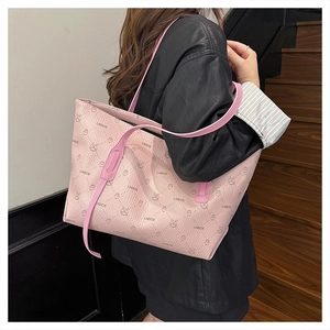Pink tote bag detail with cute cartoon bunny print and brand logo on premium leather